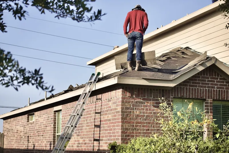 Professional roofer working on a residential roof in Riverside Rancho